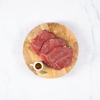 Cortes de bistec asiento sobre una tabla de cortar circular